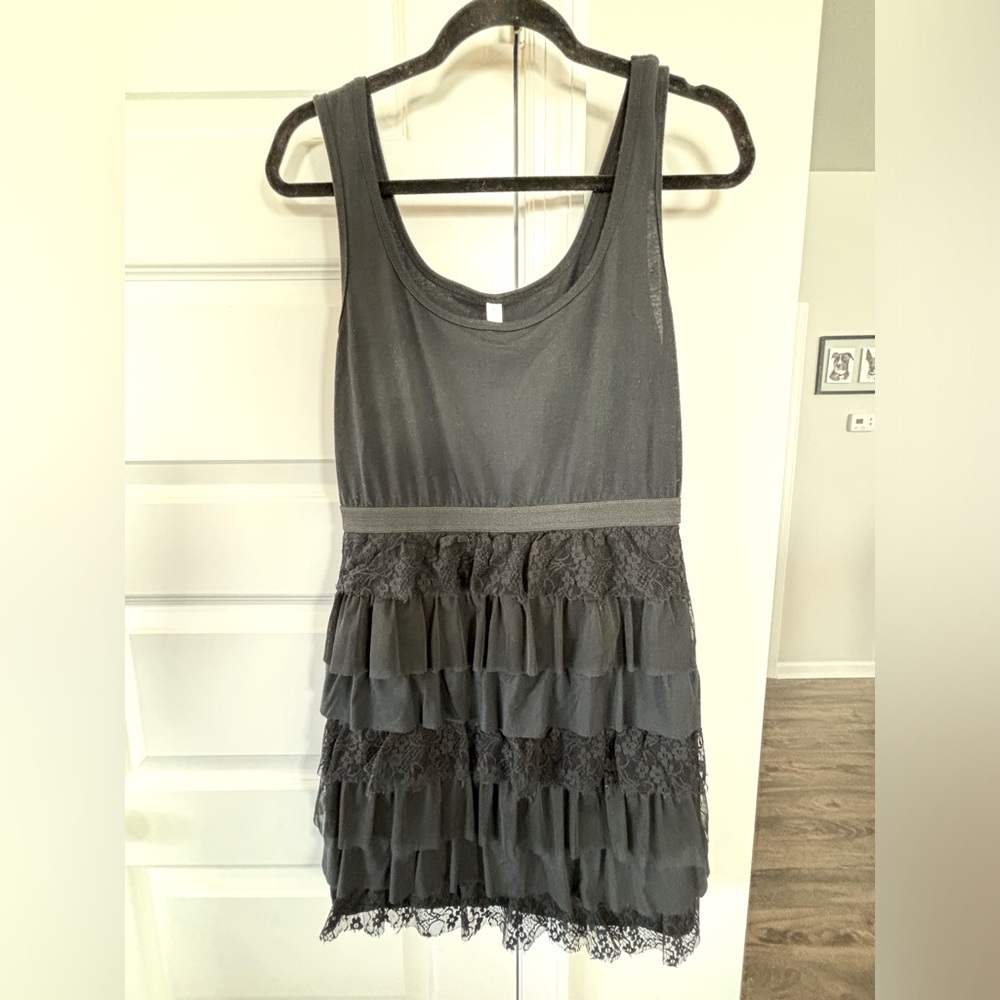 Super cute black cotton dress with lace ruffle tears.